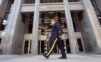A Royal Canadian Mounted Police (RCMP) officer walks past the headquarters of SNC Lavalin in Montreal April 13, 2012. Canada's Mounties were searching the Montreal headquarters of engineering giant SNC-Lavalin Group Inc on Friday following an internal company investigation that found a mysterious $56 million in improperly authorized payments.      REUTERS/Christinne Muschi (CANADA - Tags: BUSINESS)