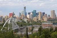 Edmonton, Alberta, Canada - July 7, 2018: Several Skyscrapers of the city downtown at sunset, and Walterdale Bridge in the foreground