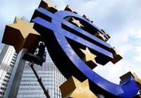 Workers maintain the huge Euro logo in front of the headquarters of the European Central Bank (ECB) in Frankfurt, Dec. 6, 2011.