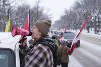 An organizer, who wished to remain anonymous, fires up the crowd during a rally near the Legislative Building in Regina on Saturday, Feb. 5, 2022. Saskatchewan wants to change its legislative security to thwart violent extremists during the COVID-19 pandemic.THE CANADIAN PRESS/Michael Bell
