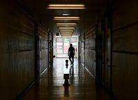 FILE PHOTO: A teacher walks the divided hallways at Hunter's Glen Junior Public School, part of the Toronto District School Board (TDSB), in Scarborough, Ontario, Canada September 14, 2020.Nathan Denette/Pool via REUTERS/File Photo