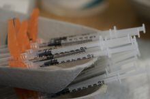 Needles are seen filled with the vaccination for COVID-19 at a truck stop on highway 91 North in Delta, B.C., Wednesday, June 16, 2021. A British Columbia pharmacist has been disciplined for falsifying provincial health records and claiming to be vaccinated against COVID-19. THE CANADIAN PRESS/Jonathan Hayward