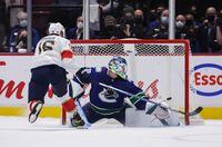 Florida Panthers' Aleksander Barkov, left, of Finland, scores the winning goal against Vancouver Canucks goalie Spencer Martin during shootout NHL hockey action in Vancouver, on Friday, January 21, 2022. THE CANADIAN PRESS/Darryl Dyck