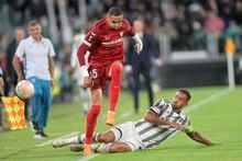 Juventus' Danilo and Sevilla's Youssef En-Nesyri charge the ball during the Europa League soccer match between Juventus and Sevilla at Allianz Stadium in Turin, Italy, Thursday, May 11, 2023. (Tano Pecoraro/LaPresse via AP)