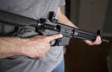 A restricted gun licence holder holds a AR-15 at his home in Langley, B.C. on May 1, 2020. The Trudeau government has awarded a contract to IBM Canada to support the development, design and implementation of a buyback program for recently prohibited firearms. The Liberals outlawed a wide range of firearms in early May, saying the guns were designed for the battlefield, not hunting or sport shooting.<br>The ban covers some 1,500 models and variants of what the government considers assault-style firearms, meaning they can no longer be legally used, sold or imported. THE CANADIAN PRESS/Jonathan Hayward