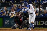 Los Angeles Dodgers' Chris Taylor hits a solo home run in the seventh inning against the Atlanta Braves in Game 5 of baseball's National League Championship Series Thursday, Oct. 21, 2021, in Los Angeles. (AP Photo/Marcio Jose Sanchez)