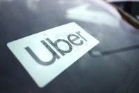 FILE - An Uber sign is displayed inside a car in Palatine, Ill., Thursday, Feb. 10, 2022. The U.S. Department of Labor is proposing a new rule on employee classifications, saying workers have incorrectly been deemed independent contractors, which hurts their rights. The department said Tuesday, Oct. 11, that misclassifying workers as independent contractors instead of employees denies employees' protections under federal labor standards, promotes wage theft, allows certain employers to gain an unfair advantage over businesses, and hurts the economy. (AP Photo/Nam Y. Huh, File)
