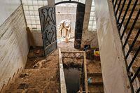 This picture taken on September 19, 2023 shows a view of a mud-covered stairwell in the house of Mohamed Badr, 23, a survivor of the flooding who lost his brother and whose house was engulfed with mud in the recent deadly flash floods in Libya's eastern city of Derna. In Libya's flood-hit town of Derna, the breeze from the Mediterranean Sea mixes with the nauseating stench of human remains buried under the rubble. Ten days after a tsunami-scale wall of water ripped through the town, razing entire neighbourhoods, the traumatised survivors are waiting to learn the fate of missing loved ones, without any illusions. (Photo by Amanda MOUAWAD / AFP) (Photo by AMANDA MOUAWAD/AFP via Getty Images)