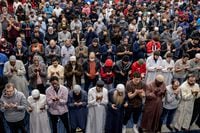 Worshippers raise their hands in supplication during the final prayer of the night, known as Witr, at Abu Huraira Mosque in Toronto on April 19, 2023.