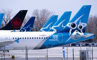 Tails of Air Transat and an Air Canada aircraft are seen on the tarmac at Montreal-Trudeau International Airport, in Montreal, Wednesday, April 8, 2020. THE CANADIAN PRESS/Paul Chiasson