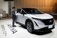 An employee opens the door of a Nissan Ariya EV car at Nissan Gallery in Yokohama, Japan November 29, 2021. REUTERS/Androniki Christodoulou
