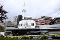 Police stand outside Dine Hoxha mosque after a knife attack in Tirana, Albania, on April 19, 2021.