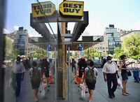 People wearing facemasks walk past a Best Buy store near Union Square on June 25, 2020 in New York City. - New York businesses opened their doors to returning waves of workers June 22 as the city that was once the epicenter of the global pandemic marked an important milestone in its return to normalcy, even as other US states were seeing an alarming rise in COVID-19 cases. (Photo by Angela Weiss / AFP) (Photo by ANGELA WEISS/AFP via Getty Images)