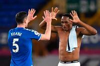 Everton's Yerry Mina, right, and Everton's Michael Keane celebrate at the end of the English Premier League soccer match between Everton and Chelsea at Goodison Park in Liverpool, England, Saturday, Dec. 12, 2020. Everton won the match 1-0. (Peter Powell/Pool via AP)