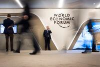 FILE - In this Jan. 24, 2019 file photo, participants walk trough the halls during the annual meeting of the World Economic Forum, WEF, in Davos, Switzerland. Organizers of the annual World Economic Forum event in Davos, Switzerland, have again changed their planned venue for next years edition due to the COVID-19 crisis, announcing it will now take place in Singapore in May and it is expected to return to Davos for the Annual Meeting 2022. (Gian Ehrenzeller/Keystone via AP, File)