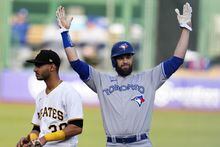 Toronto Blue Jays' Brandon Belt, right, celebrates as he stands on second base after driving in two runs with a double off Pittsburgh Pirates starting pitcher Johan Oviedo (not shown) during the first inning of a baseball game in Pittsburgh, Saturday, May 6, 2023. (AP Photo/Gene J. Puskar)