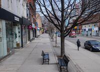 After a provincial order to shut all non-essential businesses in Ontario, a normally bustling Queen Street West is lined with closed stores and empty of shoppers in Toronto Wednesday afternoon. March 25, 2020(Melissa Tait / The Globe and Mail)
