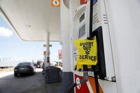 A plastic bag covering a fuel pump to signal no gas is available is seen at a Circle K gas station after a cyberattack crippled the biggest fuel pipeline in the country, run by Colonial Pipeline, in Lakeland, Florida, U.S. May 14, 2021.  REUTERS/Octavio Jones
