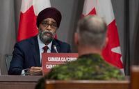 Chief of Defence Staff Jonathan Vance looks on as National Defence Minister Harjit Sajjan  makes his opening remarks at a news conference Friday, June 26, 2020 in Ottawa. THE CANADIAN PRESS/Adrian Wyld