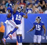 New York Giants wide receiver Amba Etta-Tawo, left, celebrates his touchdown catch with teammates wide receiver Travis Rudolph (19) and wide receiver Hunter Sharp (15) on a pass from quarterback Kyle Lauletta, not pictured, during the first half of an NFL pre-season football game against the New England Patriots, on August 30, 2018, in East Rutherford. THE CANADIAN PRESS/AP, Bill Kostroun