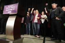 CUPE-OSBCU president Laura Walton, centre, and OPSEU president JP Hornick, right, chant along with other union heads during a press conference in Toronto on Monday Nov. 7, 2022. THE CANADIAN PRESS/Nathan Denette 