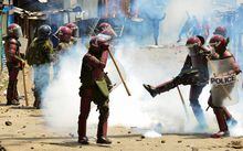 A riot police officer kicks a teargas canister lobbed to disperse supporters of Kenya's opposition leader Raila Odinga of the Azimio La Umoja (Declaration of Unity) One Kenya Alliance, as they participate in a nationwide protest over cost of living and President William Ruto's government in Mathare settlement of Nairobi, Kenya March 27, 2023. REUTERS/John Muchucha