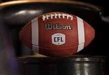 A football with the new CFL logo sits on a chair in Winnipeg, Friday, November 27, 2015. THE CANADIAN PRESS/John Woods