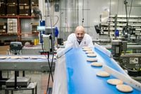 Guy Ozery, co-CEO of Ozery Bakery, checks out sandwich buns along a production line in the company's 4,000 square foot facility in Vaughan, Ontario, Thursday, May 28, 2020. (Galit Rodan/The Globe and Mail)