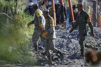Soldiers take part in an operation attempting to reach 10 miners trapped in a flooded coal mine following a landslide a week ago, in the community of Agujita, Sabinas Municipality, Coahuila State, Mexico, on August 11, 2022. - Hundreds of soldiers and other rescuers are taking part in efforts to save the miners. Five workers managed to escape from the crudely constructed mine in the initial aftermath of the accident on August 3, but there has been no contact with the others. (Photo by Pedro PARDO / AFP) (Photo by PEDRO PARDO/AFP via Getty Images)