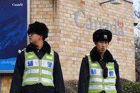 Police officers stand guard outside the Canadian embassy in Beijing on January 27, 2019. - Canadian Prime Minister Justin Trudeau on January 26 said he had sought and accepted the resignation of Ottawa's ambassador to China, days after the diplomat sparked controversy with criticism of the US extradition request for a top Huawei executive. (Photo by GREG BAKER / AFP)        (Photo credit should read GREG BAKER/AFP via Getty Images)