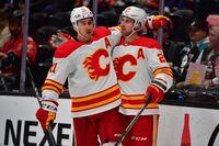 Mar 21, 2023; Anaheim, California, USA; Calgary Flames center Elias Lindholm (28) celebrates his power play goal scored against the Anaheim Ducks with center Mikael Backlund (11) during the third period at Honda Center.  Backlund provided an assist on the goal. Mandatory Credit: Gary A. Vasquez-USA TODAY Sports