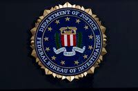 FILE - This Thursday, June 14, 2018, file photo, shows the FBI seal at a news conference at FBI headquarters in Washington.