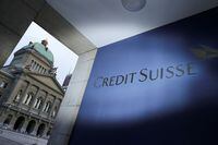 FILE PHOTO: The logo of Credit Suisse is pictured in front of the Swiss Parliament Building, in Bern, Switzerland, March 19, 2023. REUTERS/Denis Balibouse/