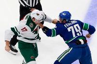 Marcus Foligno of the Minnesota Wild fights with Micheal Ferland of the Vancouver Canucks in Game One of the Western Conference Qualification Round at Rogers Place in Edmonton on August 2, 2020.