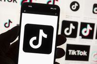 The TikTok logo is seen on a cellphone on Oct. 14, 2022, in Boston. Manitoba has joined other provinces in the move to ban the use of the TikTok social media app on government-owned devices. THE CANADIAN PRESS/AP-Michael Dwyer