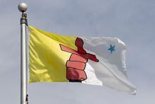 Nunavut's territorial flag flies on a flag pole in Ottawa, Tuesday June 30, 2020. The Nunavut government has declared a state of emergency in Kinngait to help restore water services in the hamlet.THE CANADIAN PRESS/Adrian Wyld