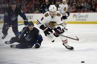 Chicago Blackhawks defenseman Jake McCabe, right, chases the puck during the first period of an NHL hockey game against the Toronto Maple Leafs, Sunday, Feb. 19, 2023, in Chicago. The Toronto Maple Leafs have acquired McCabe and forward Sam Lafferty in a trade with the Chicago Blackhawks.THE CANADIAN PRESS/AP-Erin Hooley
