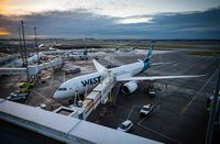A WestJet Airlines Boeing 787-9 Dreamliner is seen parked at a gate at Vancouver International Airport, in Richmond, B.C., on January 21, 2021. WestJet is arguing it shouldn't have to compensate a passenger who filed a complaint with the Canadian Transportation Agency last year about a last-minute flight cancellation prompted by a lack of staff. THE CANADIAN PRESS/Darryl Dyck