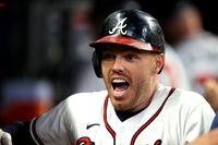 ATLANTA, GEORGIA - OCTOBER 12: Freddie Freeman #5 of the Atlanta Braves reacts after hitting a home run during the eighth inning against the Milwaukee Brewers in game four of the National League Division Series at Truist Park on October 12, 2021 in Atlanta, Georgia. (Photo by Todd Kirkland/Getty Images)