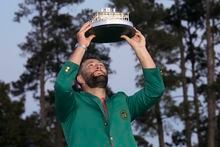 Jon Rahm, of Spain, holds up the trophy after winning the Masters golf tournament at Augusta National Golf Club on Sunday, April 9, 2023, in Augusta, Ga. (AP Photo/David J. Phillip)