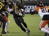 Hamilton Tiger Cats running back Don Jackson (5) runs for a gain during first half CFL football game action against the BC Lions in Hamilton, Ont. on Friday, November 5, 2021. THE CANADIAN PRESS/Peter Power