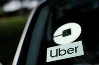 FILE PHOTO: An Uber logo is shown on a rideshare vehicle during a statewide day of action to demand that ride-hailing companies Uber and Lyft follow California law and grant drivers "basic employee rights'', in Los Angeles, California, U.S., August 20, 2020. REUTERS/Mike Blake/File Photo