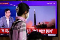 FILE PHOTO: A woman watches a TV broadcasting a news report on North Korea's launch of three missiles including one thought to be an intercontinental ballistic missile (ICBM), in Seoul, South Korea, May 25, 2022.   REUTERS/Kim Hong-Ji