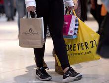 A shopper carries purchases at Ottawa's Rideau Centre mall on Boxing Day, Wednesday, Dec. 26, 2018. Statistics Canada says retail sales rose 0.5 per cent to $62.1 billion in December. THE CANADIAN PRESS/Justin Tang