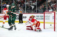 Apr 28, 2022; Saint Paul, Minnesota, USA; Minnesota Wild left wing Marcus Foligno (17) watches as a puck shot by defenseman Jonas Brodin (25) gets past Calgary Flames goaltender Jacob Markstrom (25) on the power play in the second period at Xcel Energy Center. Mandatory Credit: David Berding-USA TODAY Sports