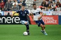 Apr 2, 2022; Vancouver, British Columbia, CAN;  Sporting Kansas City midfielder Remi Walter (54) controls the ball against Vancouver Whitecaps forward Lucas Cavallini (9) during the second half at BC Place. Mandatory Credit: Anne-Marie Sorvin-USA TODAY Sports