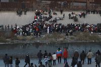 FILE - Migrants gather at a crossing into El Paso, Texas, as seen from Ciudad Juarez, Mexico, Dec. 20, 2022. The Biden administration on Thursday, Jan. 5, said it would immediately begin turning away Cubans, Haitians and Nicaraguans who cross the U.S.-Mexico border illegally, a major expansion of an existing effort to stop Venezuelans attempting to enter the U.S. (AP Photo/Christian Chavez, File)