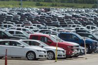 Vehicles are seen in a parking lot at the General Motors Oshawa Assembly Plant in Oshawa, Ont., on June 20, 2018. Statistics Canada says the country's merchandise trade deficit grew to $1.5 billion in January compared with $732 million in December as exports fell. THE CANADIAN PRESS/Tijana Martin