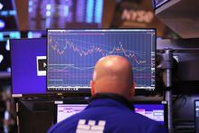 Traders work on the floor of the New York Stock Exchange during morning trading on May 30.