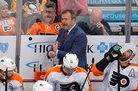 Philadelphia Flyers head coach Alain Vigneault, top center, stands behind his bench during the first period of an NHL hockey game against the Pittsburgh Penguins in Pittsburgh, Thursday, Nov. 4, 2021. (AP Photo/Gene J. Puskar)